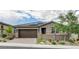 Charming single-story home with desert landscaping, a tile roof, solar panels and a two-car garage at 10182 Skye Run Ave, Las Vegas, NV 89166