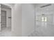 Hallway leading to the living room featuring white walls and marble tile floors at 10182 Skye Run Ave, Las Vegas, NV 89166