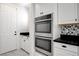 Gourmet kitchen appliances, double ovens, and black countertops at 10182 Skye Run Ave, Las Vegas, NV 89166