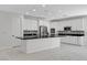 Open kitchen featuring white cabinets, island, and marble floors at 10182 Skye Run Ave, Las Vegas, NV 89166