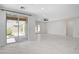 Bright and airy living space with sliding glass doors to the backyard and tile floors throughout at 10182 Skye Run Ave, Las Vegas, NV 89166