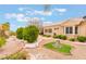 Well-maintained backyard featuring desert landscaping, lush greenery, and custom stone hardscape at 10508 Snyder Ave, Las Vegas, NV 89134