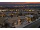 Night aerial view of a well-lit neighborhood with city views in the background at 1060 Calico Ridge Dr, Henderson, NV 89011