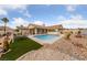 Spacious backyard featuring a sparkling swimming pool and desert landscaping at 1060 Calico Ridge Dr, Henderson, NV 89011