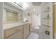 Neutral bathroom with vanity, mirror, and marble-look shower at 1060 Calico Ridge Dr, Henderson, NV 89011