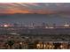 Enjoy breathtaking city and mountain views from this home, showcasing the vibrant cityscape lights at dusk at 1060 Calico Ridge Dr, Henderson, NV 89011