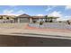 Charming one-story home with a terra cotta roof, two-car garage, and desert landscaping with an elevated planter at 1060 Calico Ridge Dr, Henderson, NV 89011