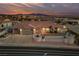 Inviting single-story home featuring a terra cotta roof, desert landscaping, and attached two-car garage at sunset at 1060 Calico Ridge Dr, Henderson, NV 89011