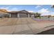 Charming single-story home featuring a terra cotta roof, two-car garage, and desert landscaping with an elevated planter at 1060 Calico Ridge Dr, Henderson, NV 89011