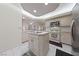 Bright kitchen featuring a center island, modern appliances, and white cabinetry at 1060 Calico Ridge Dr, Henderson, NV 89011