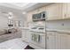Bright kitchen featuring white cabinets, a gas range, and stainless steel microwave at 1060 Calico Ridge Dr, Henderson, NV 89011