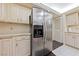 Kitchen featuring stainless steel refrigerator with white cabinets and ample counter space at 1060 Calico Ridge Dr, Henderson, NV 89011