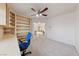 Cozy office space with a ceiling fan, built-in bookcase, desk, and plush carpet at 1060 Calico Ridge Dr, Henderson, NV 89011