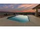 Refreshing in-ground swimming pool offering a serene retreat with desert landscaping and views of the sunset at 1060 Calico Ridge Dr, Henderson, NV 89011