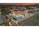 Dusk aerial view of the desert home with a private pool, outdoor lighting, and desert landscaping at 1060 Calico Ridge Dr, Henderson, NV 89011