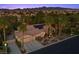 Expansive desert home with solar panels, tile roof, and tropical landscaping overlooking the city and mountains at 10674 Chillingham Dr, Las Vegas, NV 89183