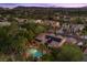 A beautiful aerial view of a home with a pool, solar panels, desert landscape and mountain views at 10674 Chillingham Dr, Las Vegas, NV 89183