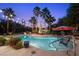 Tranquil backyard oasis showcasing a private pool, swaying palm trees, and cozy lounge spots at 10674 Chillingham Dr, Las Vegas, NV 89183