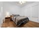 Bedroom featuring wood floors, soft natural light, and warm neutral decor at 10674 Chillingham Dr, Las Vegas, NV 89183