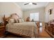 Cozy bedroom with a comfortable bed, wood floors, and windows for natural light at 10674 Chillingham Dr, Las Vegas, NV 89183