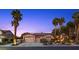 Charming single-story home with a three-car garage and beautiful desert landscaping with mature palms at 10674 Chillingham Dr, Las Vegas, NV 89183