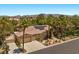 Beautiful desert home with a tile roof, mature landscaping, and solar panels for energy efficiency at 10674 Chillingham Dr, Las Vegas, NV 89183