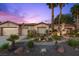 Inviting desert home with a well-manicured front yard, mature palm trees, and a two-car garage at 10674 Chillingham Dr, Las Vegas, NV 89183