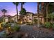 Charming desert home featuring an arched entryway, lush tropical landscaping, and a winding walkway at 10674 Chillingham Dr, Las Vegas, NV 89183