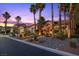 Attractive single-story home with desert landscaping, a courtyard, and exterior lighting at dusk at 10674 Chillingham Dr, Las Vegas, NV 89183