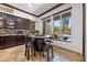 Cozy breakfast nook with a barrel table and seating looks out to the refreshing backyard pool at 10674 Chillingham Dr, Las Vegas, NV 89183