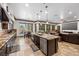 Open-concept kitchen with granite countertops, stainless steel appliances and access to the living area at 10674 Chillingham Dr, Las Vegas, NV 89183