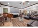 Bright living area with hardwood floors, fireplace, large screen and leather furniture at 10674 Chillingham Dr, Las Vegas, NV 89183