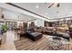 Spacious living room boasts leather furniture, area rug, and an adjacent kitchen at 10674 Chillingham Dr, Las Vegas, NV 89183