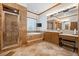 Luxurious bathroom featuring a walk-in shower, soaking tub, and dual vanity sinks at 10674 Chillingham Dr, Las Vegas, NV 89183