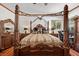 Comfortable main bedroom with a four-poster bed, two nightstands, and a window at 10674 Chillingham Dr, Las Vegas, NV 89183