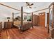 Spacious main bedroom featuring a four-poster bed, hardwood floors, and custom wood trim at 10674 Chillingham Dr, Las Vegas, NV 89183