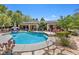 Swimming pool with adjacent spa, landscaping, and covered patio area for outdoor enjoyment at 10674 Chillingham Dr, Las Vegas, NV 89183