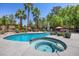 Beautiful backyard pool, integrated spa, and manicured landscaping for the ideal outdoor living space at 10674 Chillingham Dr, Las Vegas, NV 89183