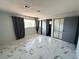 Bedroom features sleek marble floors, natural light, and mirrored closet doors at 1304 Bonita Ave, Las Vegas, NV 89104