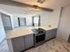 Well-equipped kitchen with stainless steel appliances, gray cabinets and a breakfast bar at 1304 Bonita Ave, Las Vegas, NV 89104