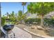 Charming backyard with patio, bbq grill, and outdoor dining set, surrounded by mature trees and lush greenery at 1314 Doggett Ave, Las Vegas, NV 89123