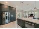 Open-concept kitchen featuring stainless steel appliances, a breakfast bar, and a view of the backyard at 1314 Doggett Ave, Las Vegas, NV 89123