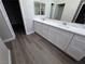 Bright bathroom featuring double vanity with white cabinets and modern fixtures at 1345 N Hollywood Blvd, Las Vegas, NV 89110