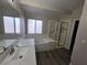 Bathroom featuring a separate shower and tub, with wood-look flooring and quartz countertops at 1345 N Hollywood Blvd, Las Vegas, NV 89110