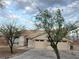 Neutral stucco home with a tile roof, a two-car garage, and easy-care desert landscaping at 1345 N Hollywood Blvd, Las Vegas, NV 89110
