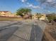 Spacious vacant lot featuring native trees, shrubs, and a long concrete driveway at 1345 N Hollywood Blvd, Las Vegas, NV 89110