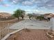 View of a large lot featuring native trees, desert landscaping, and a long concrete driveway at 1345 N Hollywood Blvd, Las Vegas, NV 89110