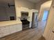 Kitchen featuring stainless steel appliances, white cabinetry, and wood-look flooring at 1345 N Hollywood Blvd, Las Vegas, NV 89110