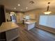 Open concept kitchen with modern white cabinets, quartz countertops, and hardwood floors at 1345 N Hollywood Blvd, Las Vegas, NV 89110