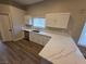 Bright kitchen featuring white cabinets, quartz countertops, a sink, and hardwood floors at 1345 N Hollywood Blvd, Las Vegas, NV 89110